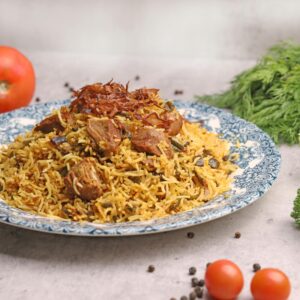 A beautifully plated lamb biryani dish with fresh herbs and vegetables, ideal for gourmet food lovers.